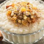 instant-pot-vegan-coconut-rice-pudding-recipe Instant pot vegan coconut rice pudding recipe. Delicious dessert cooked in an instant pot and served with nuts and ground cinnamon. #instantpot #pressurecooker #dessert #rice #pudding #vegan #vegetarian #homemade