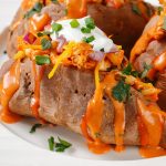 Air fryer loaded sweet potatoes recipe. Looking for a healthy alternative to fried potatoes? Try these baked sweet potatoes loaded with Cheddar cheese, sour cream, and red onions. #airfryer #dinner #potatoes #easy #healthy