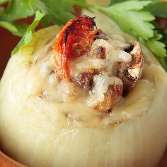 slow-cooker-stuffed-onions-recipe Slow Cooker stuffed onions recipe. Get cozy by the fire this winter with a batch of these slow cooker stuffed onions. It's a great appetizer that's even better as leftovers. #slowcooker #crockpot #recipes #appetizers #dinner #homemade #healthy #easy #yummy #delicious